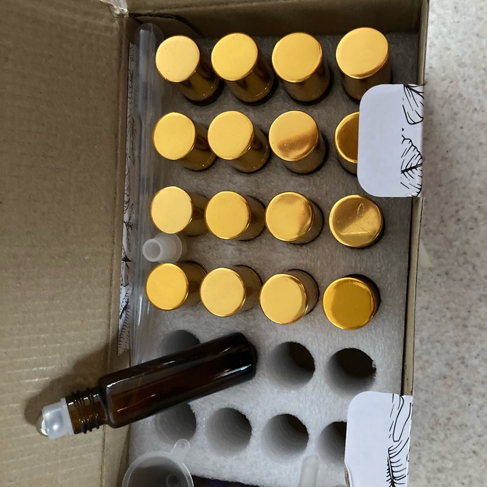 Empty amber glass essential oil roller bottles